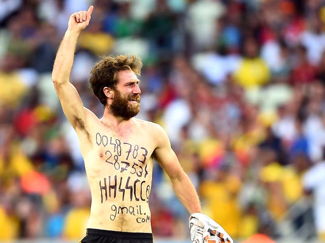 A pitch invader runs on the field during the 2014 World Cup Group G match between Germany and Ghana