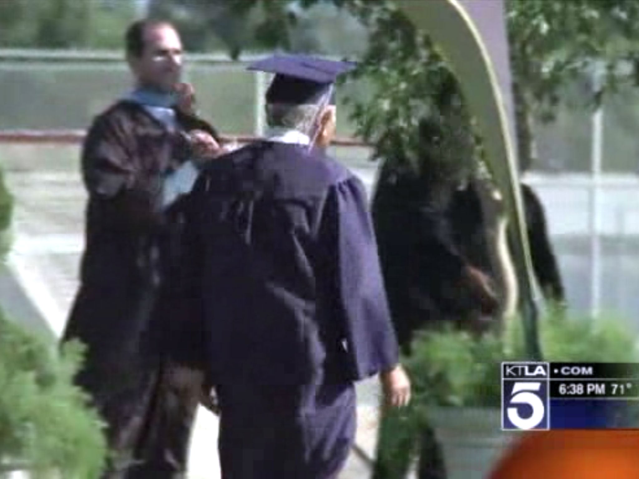 Mr Miyada takes to the stage along with 560 seniors at Newport Harbor High School - just 72 years late (KTLA)