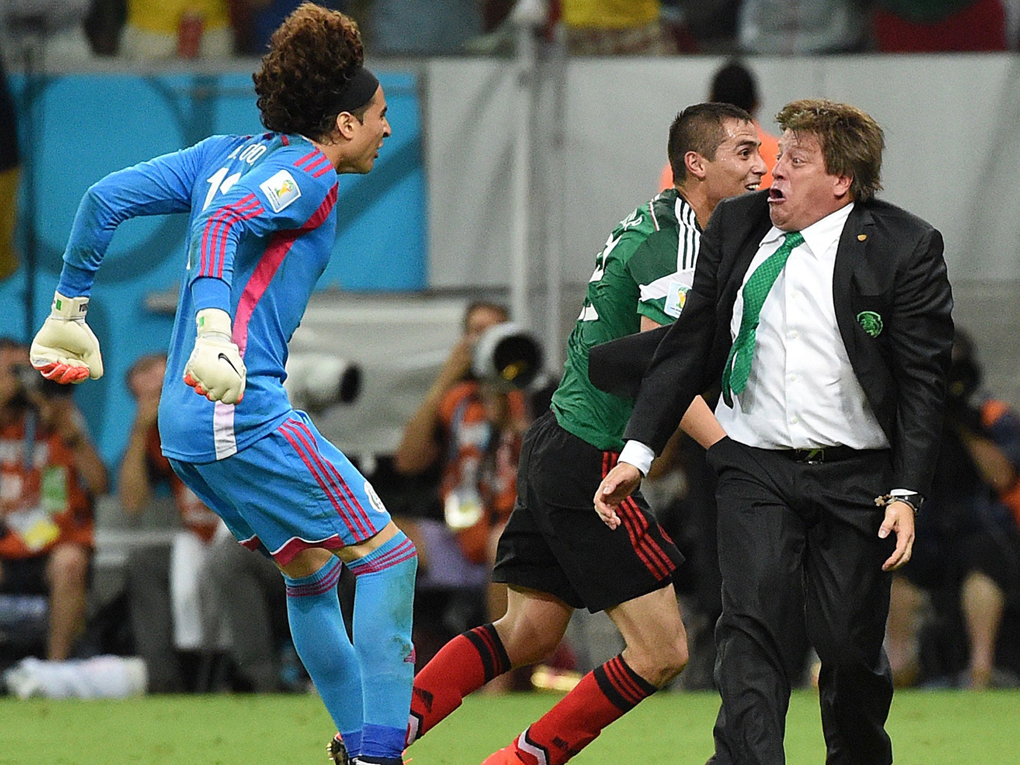 Herrera realises that all six-foot of Guillermo Ochoa is about to hit him head-on