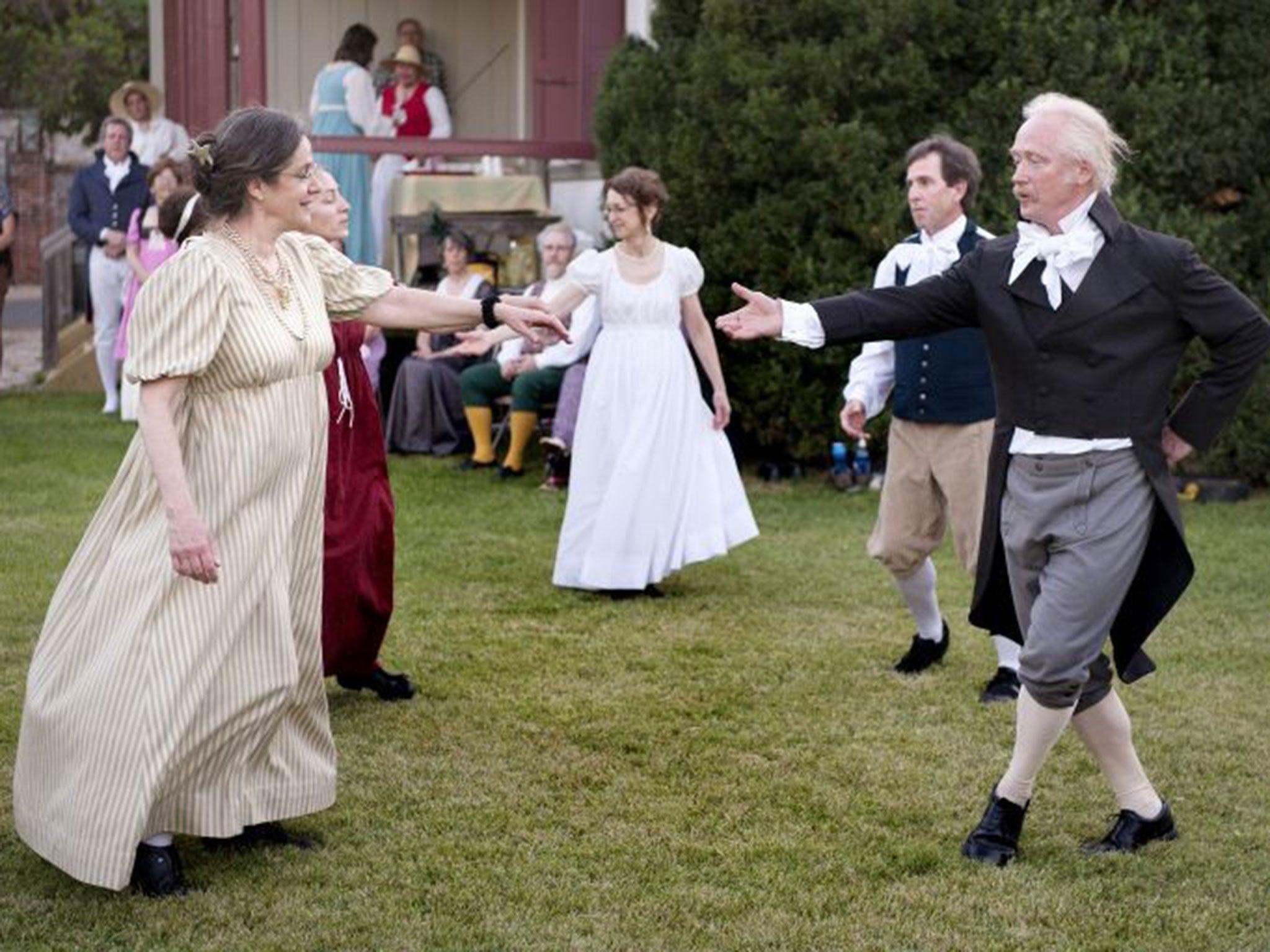 In this June 14, 2014 photo, Dance Discovery members Rebecca Taylor, left, and Tim Hirzel join other members of the troupe in French colonial dance at the Felix Valle House State Historic Site during the annual French Heritage Festival in Ste. Genevieve,