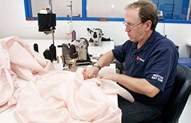 Takata employee sews an airbag at Takata's current crash-testing facility August 19, 2010 in Auburn Hills, Michigan