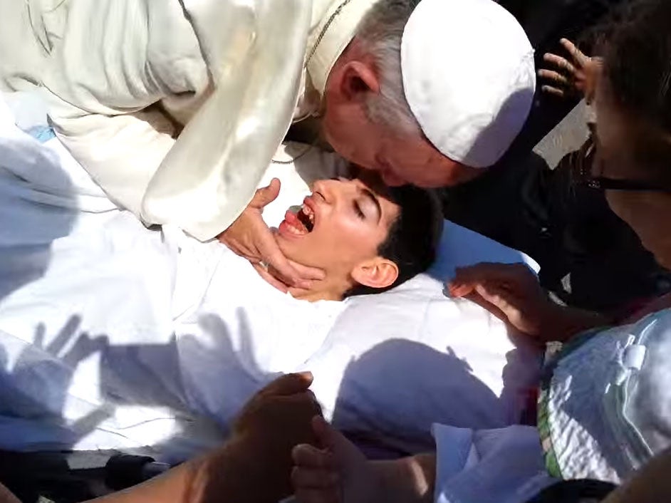 Pope Francis kisses Roberta on the side of a road in Italy