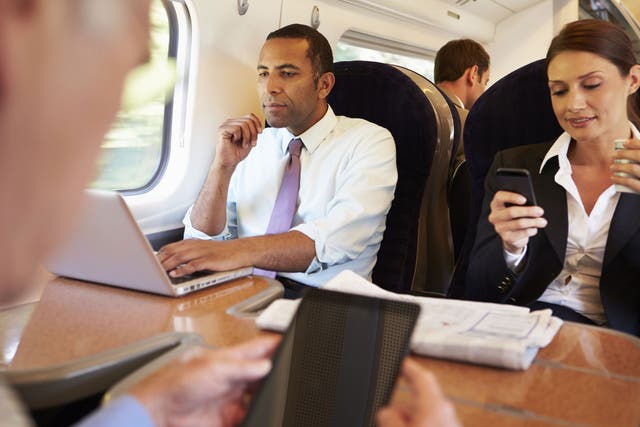 Commuters using their phones