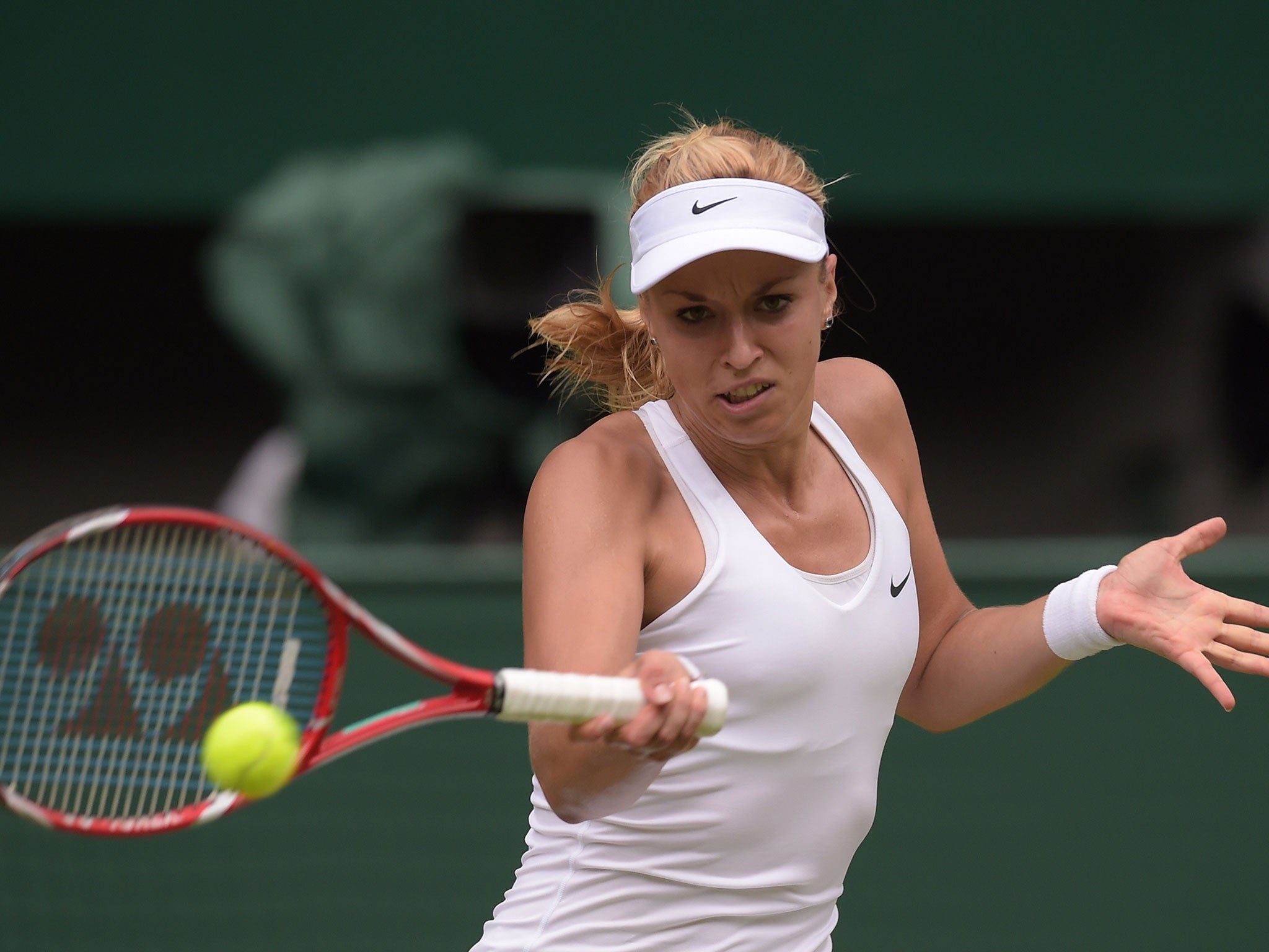 Germany's Sabine Lisicki returns against Israel's Julia Glushko during their women's singles first round match on day two of the 2014 Wimbledon