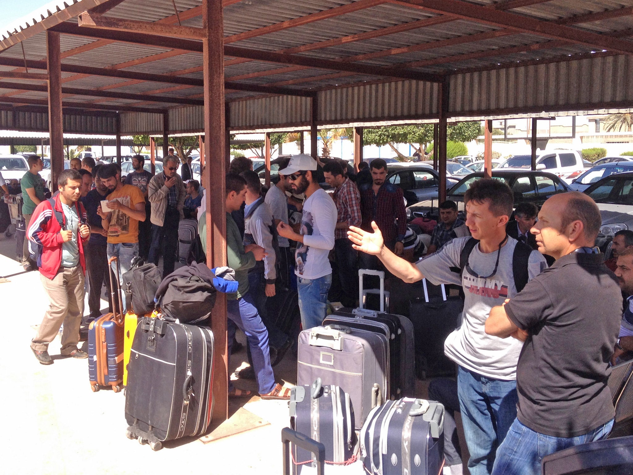 Turkish citizens at Misrata Airport on their way out of eastern Libya after they were threatened with arrest over spying claims (Getty)