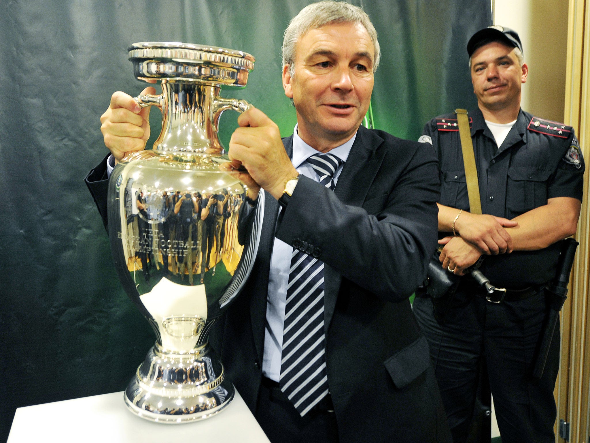 UEFA Events CEA Director David Taylor (L) holds up the UEFA Europen Championship Cup during its presentation in Kiev on July 20, 2011.