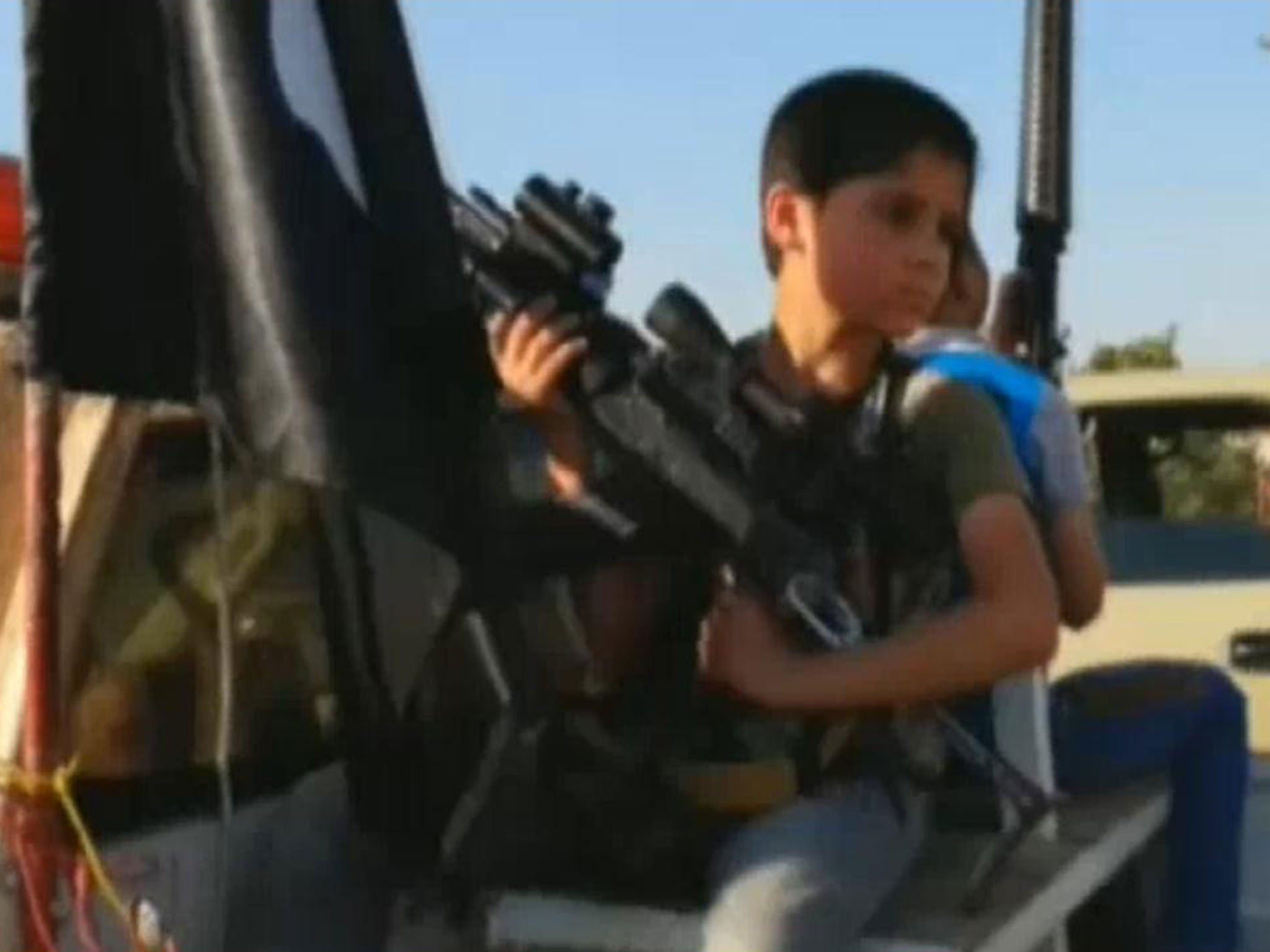 A boy shown with Isis militants near Mosul