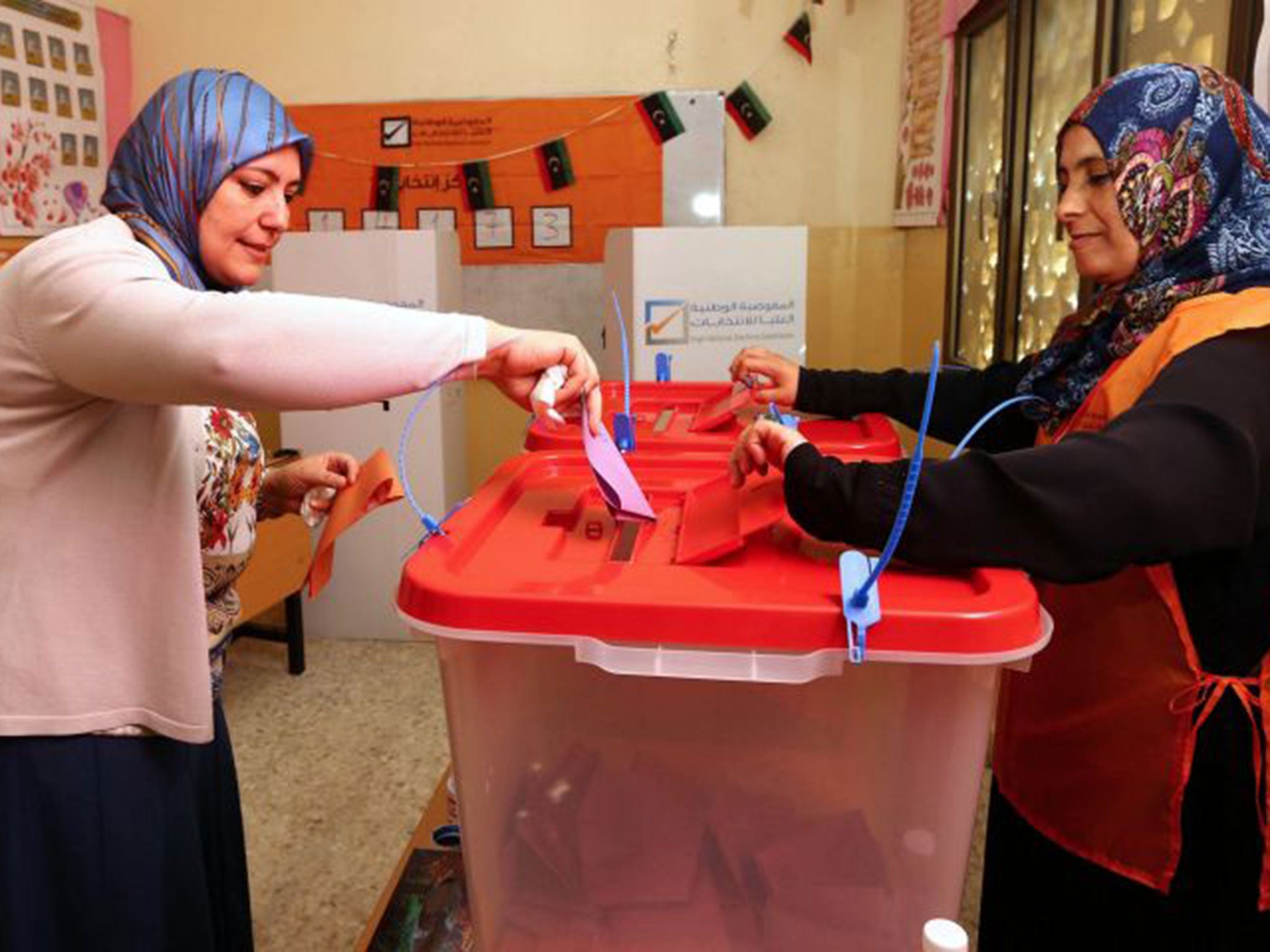 A Libyan woman casts her ballot at a polling station in Tripoli