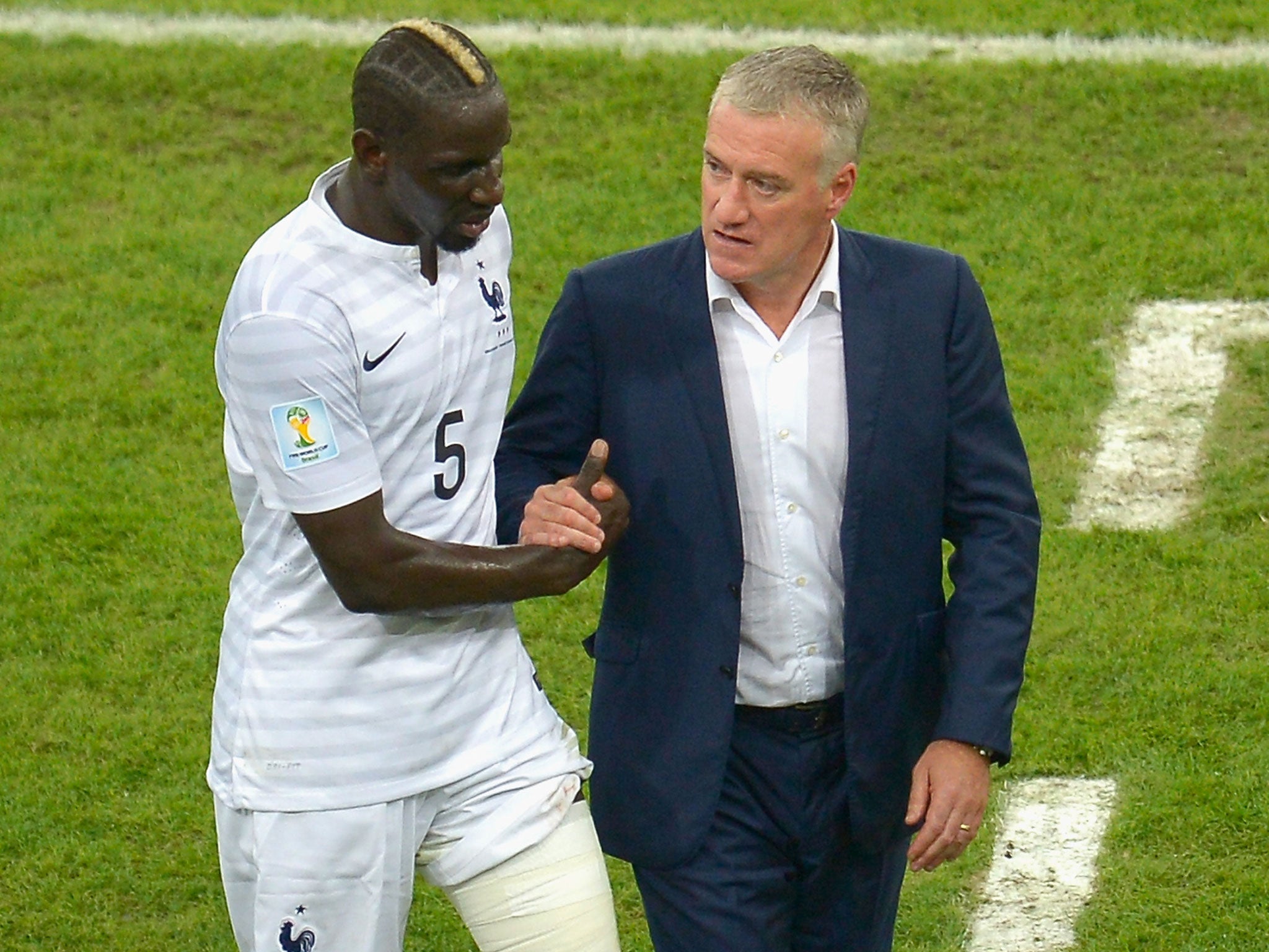 Mamadou Sakho speaks with manager Dider Deschamps as he leaves the field during the 0-0 draw with Ecuador