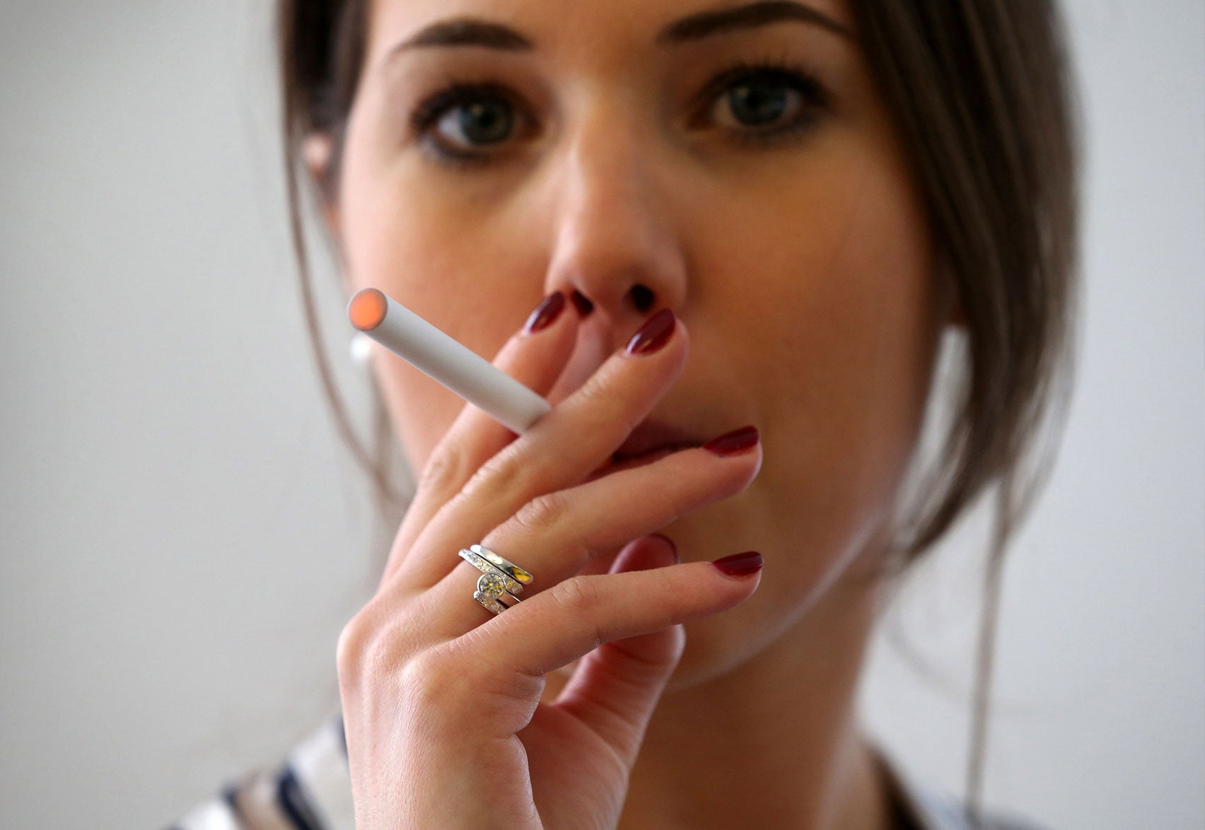 Illustration a woman smokes an e-cigarette on April 2, 2014 in London, England