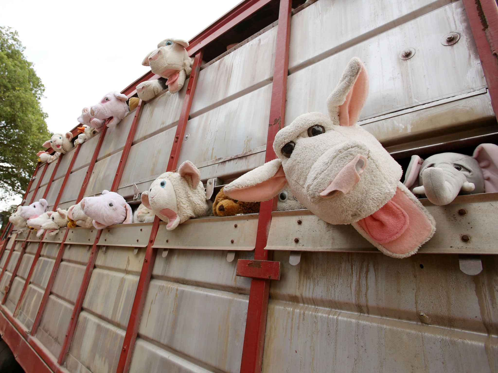 A sculpture by Banksy, entitled 'The Sirens of the Lambs', depicting a truck full of shrieking cuddly animals being driven to slaughter, drives around the Glastonbury Festival, at Worthy Farm in Somerset