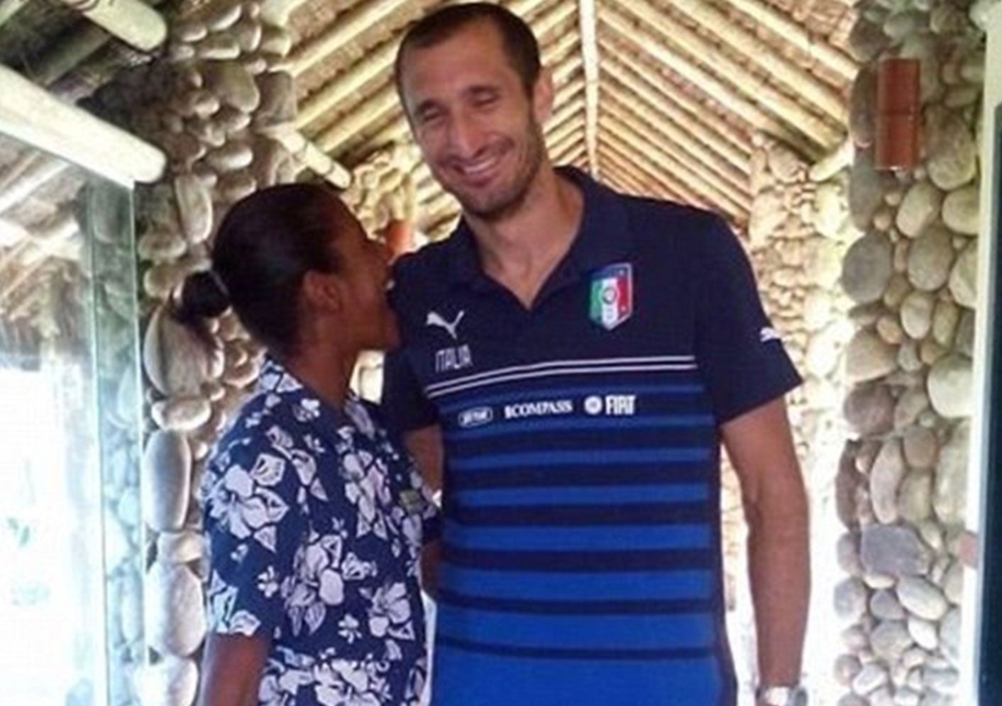 Suarez bite: Giorgio Chiellini poses next to a hotel maid pictured bitting his shoulder