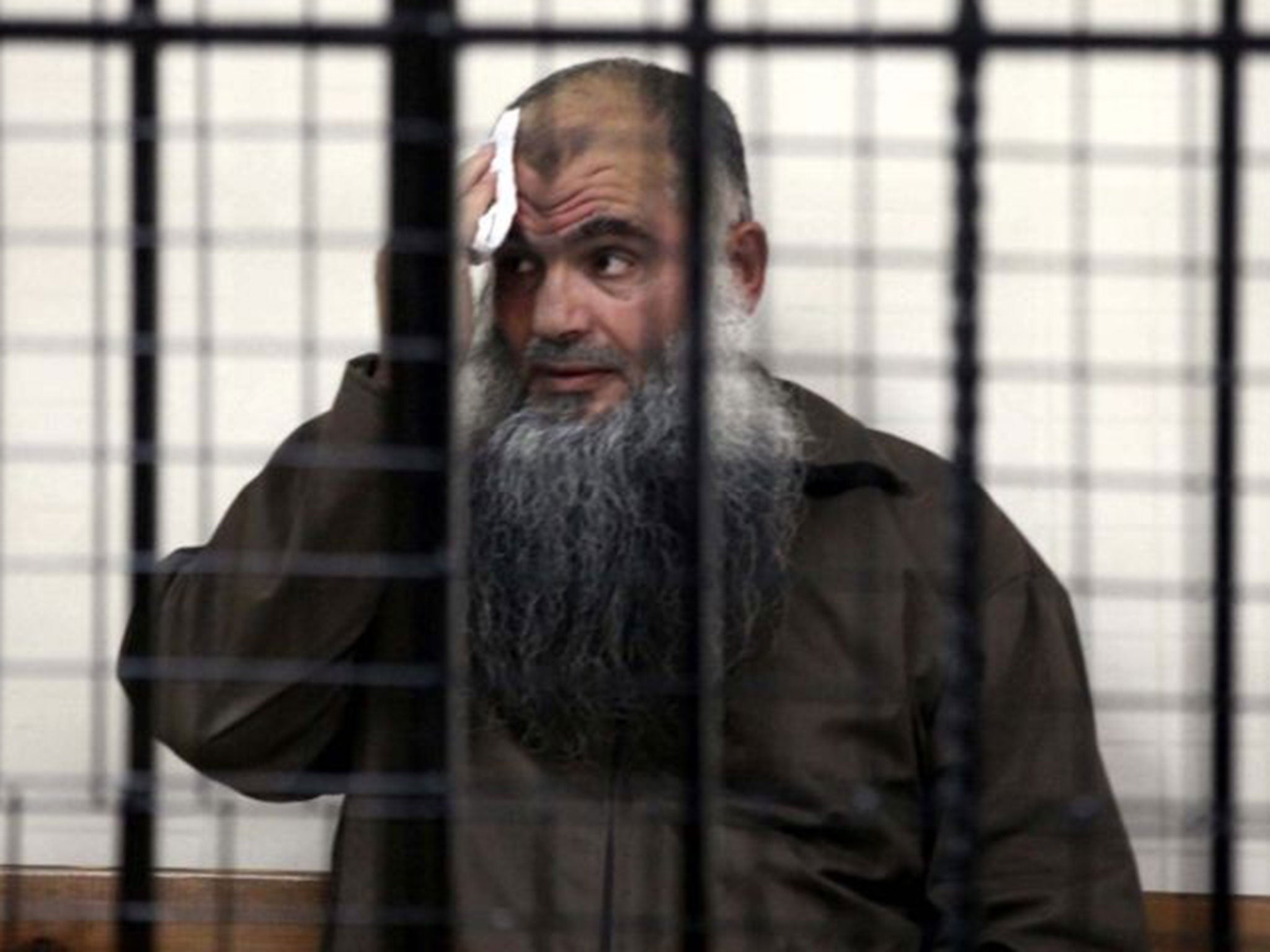 Abu Qatada behind bars in court. The radical Islamist preacher will not be allowed to return to Britain.