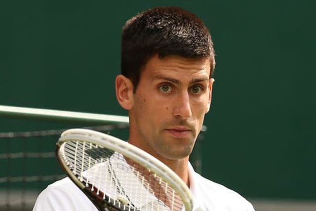 Protection racket: When Djokovic steps out in front of the crowd he is stony-faced