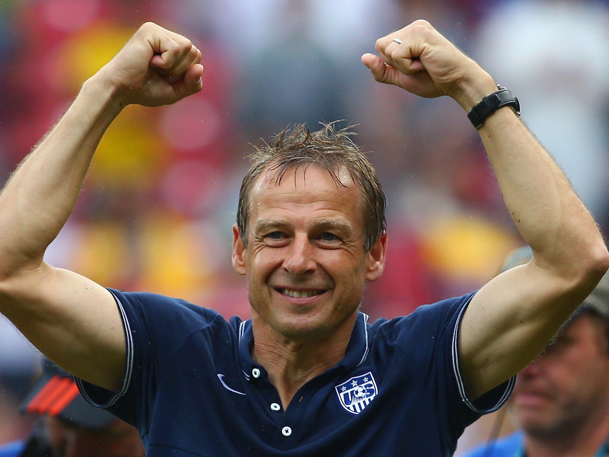 Jurgen Klinsmann celebrates after USA advance despite defeat to Germany