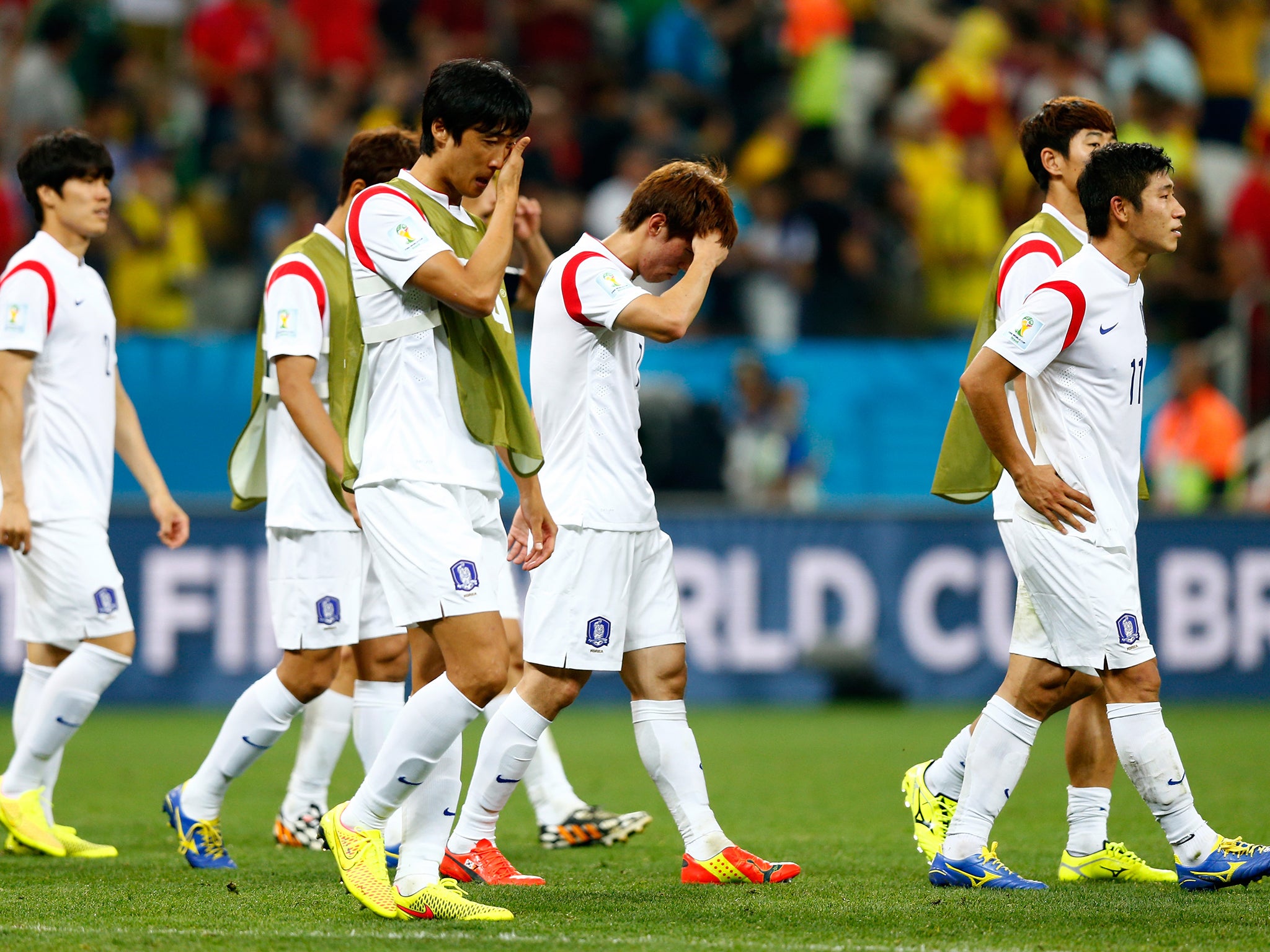 South Korea players look dejected after a 0-1 defeat to Belgium in the 2014 FIFA World Cup