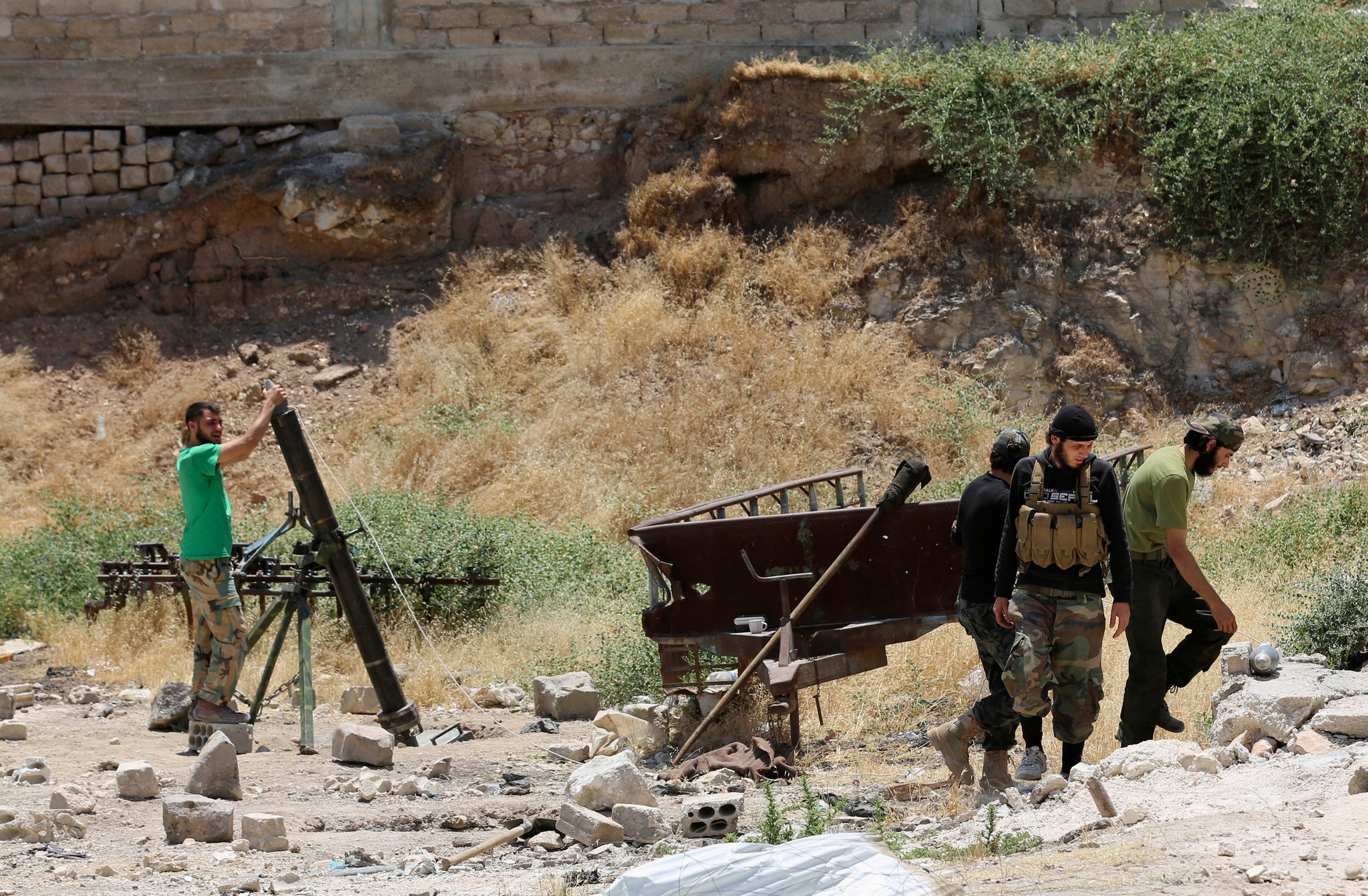 Syrian rebel fighters prepare to launch improvised mortars