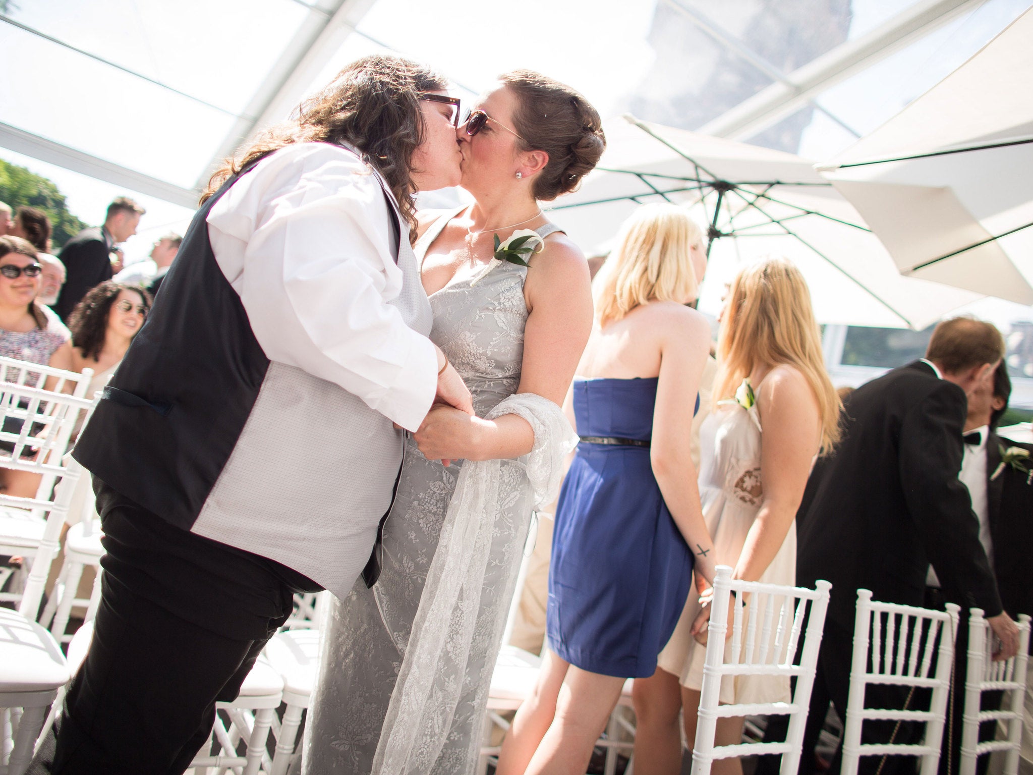 Caption:A couple seals their marriage with a kiss as over one hundred of other LGBT couples celebrate their nuptials at the Grand Pride Wedding, a mass gay wedding at Casa Loma in Toronto, Canada, on June 26, 2014.