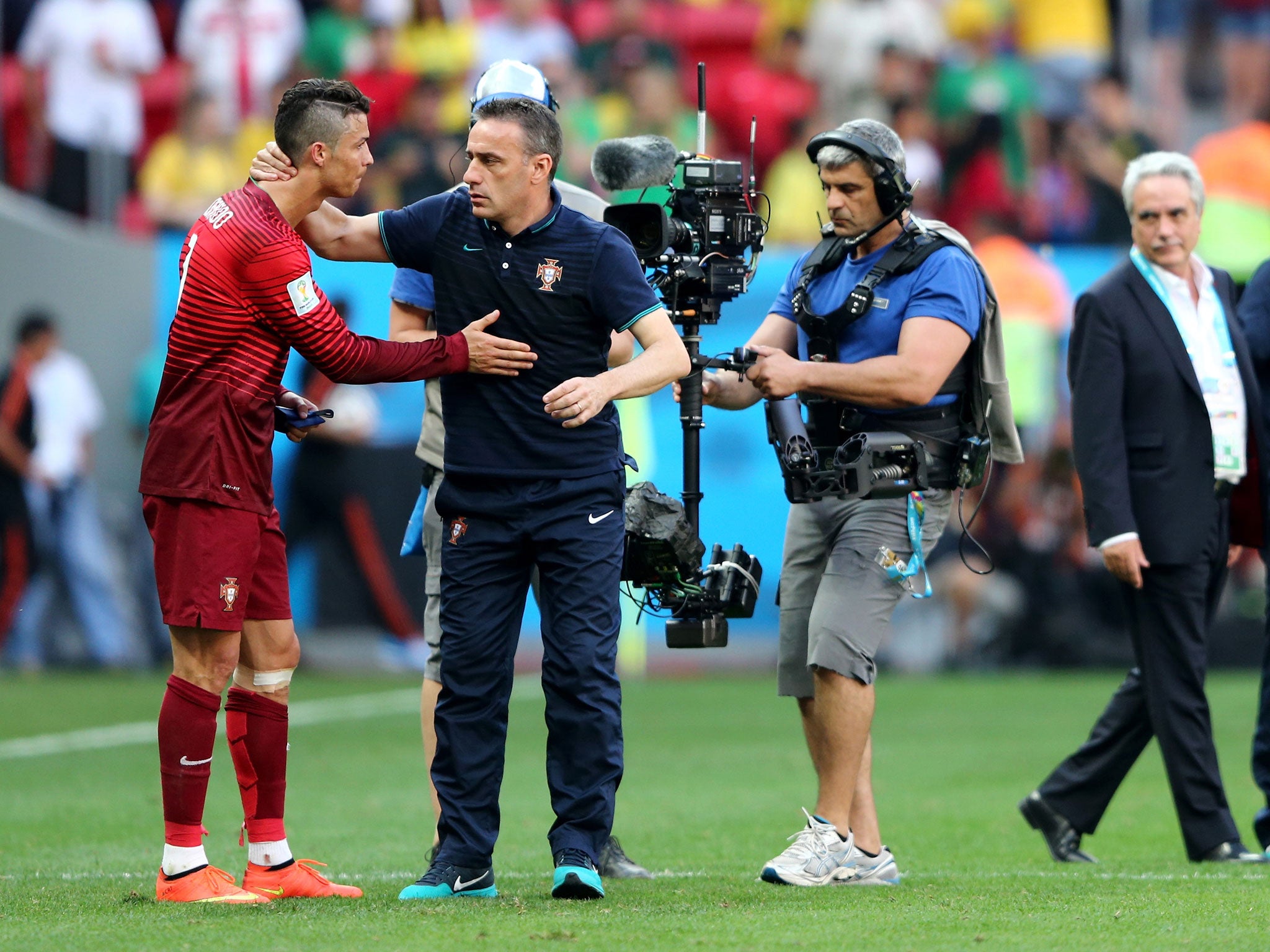 Paulo Bento consoles Cristiano Ronaldo after Portugal are knocked out of the World Cup