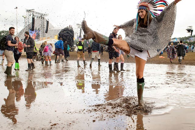 Festival-goers enjoy the mud at Glastonbury Festival 