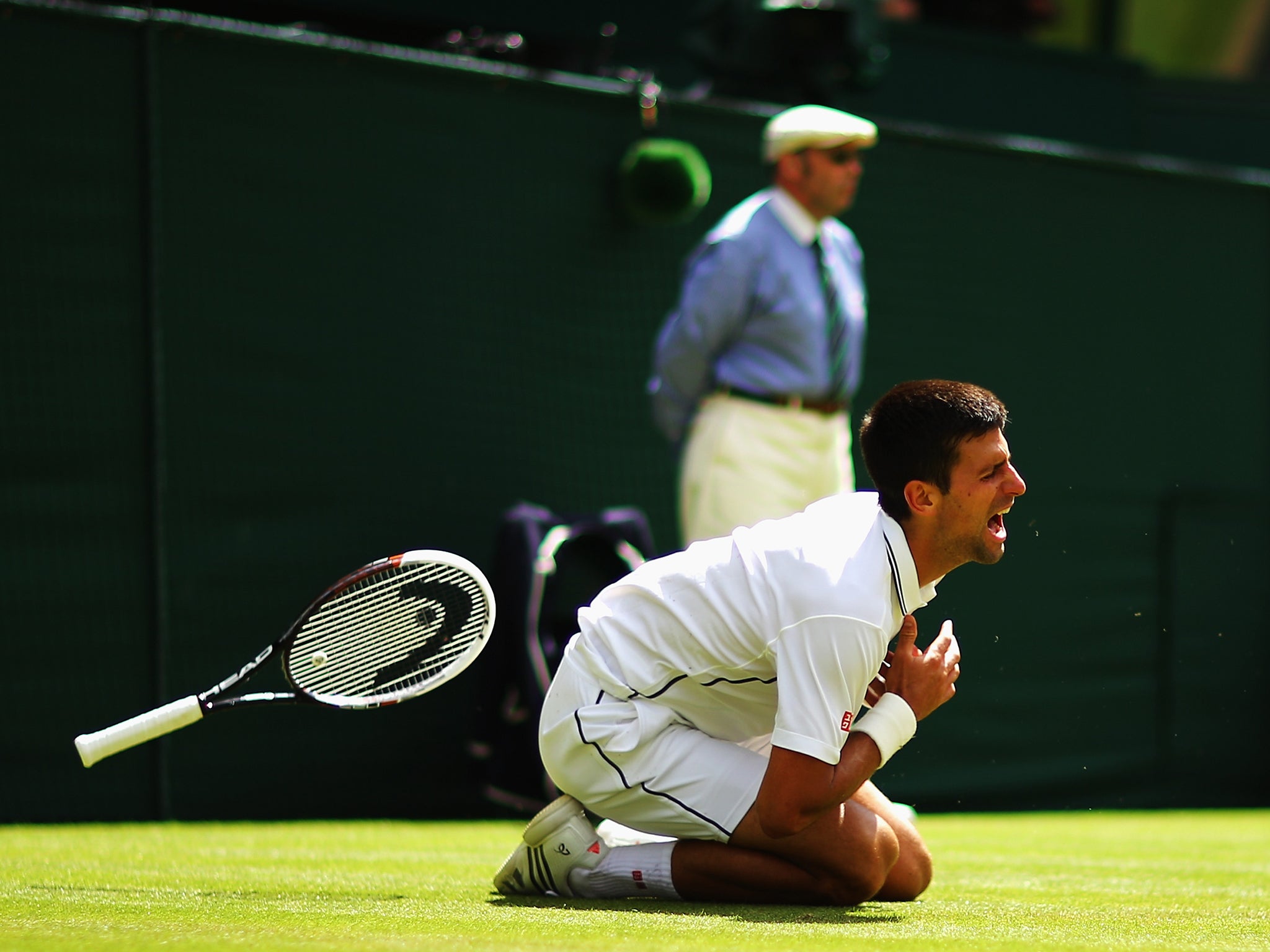Novak Djokovic tumbles during his victory over Gilles Simon