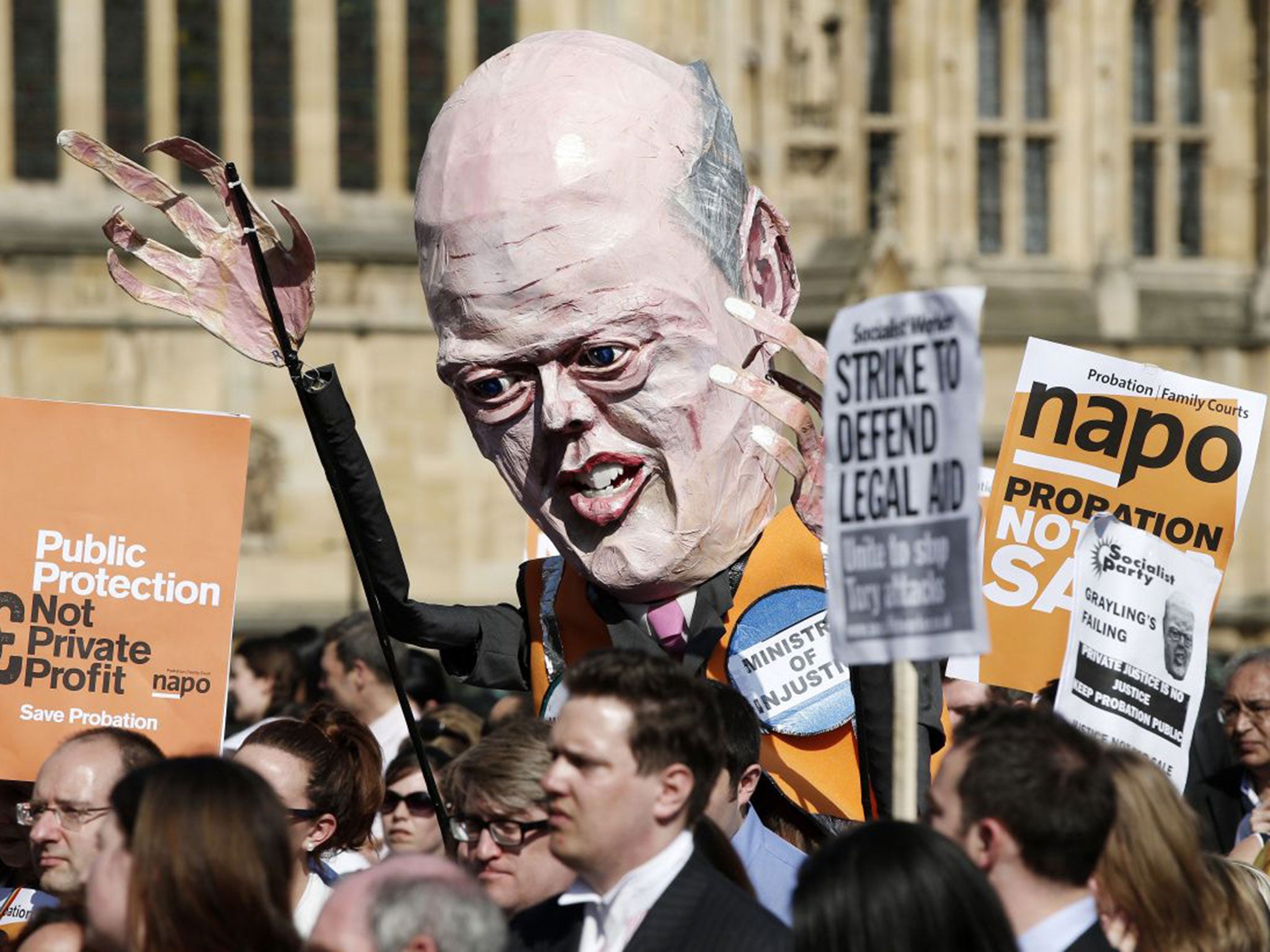 An effigy of Justice Secretary Chris Grayling is held up by National Association of Probation Officers protestors outside the Houses of Parliament