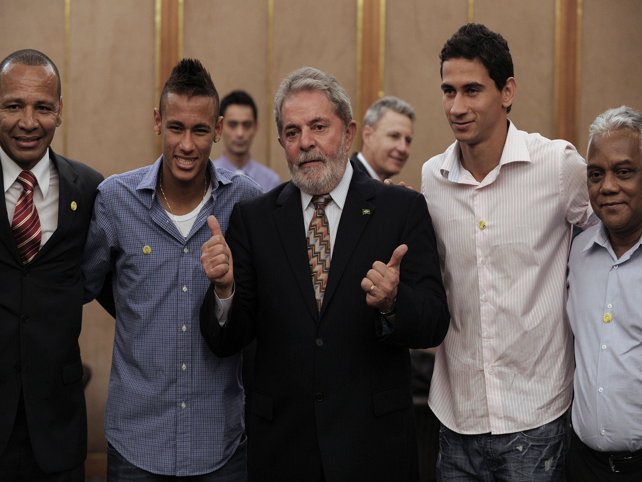 Neymar (second left) alongside his father Neymar snr (left) and Santos president Luis Álvaro (centre) in August 2010 after snubbing Chelsea's offer