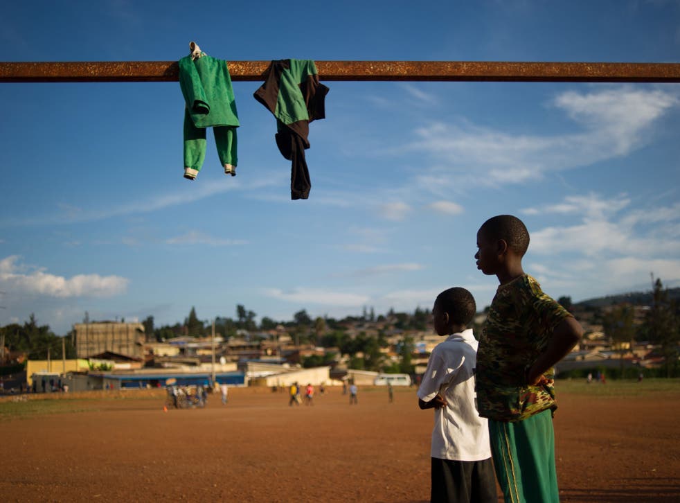 Rwandan youths watch a football game on March 16, 2014 at Gikondo suburb in the capital, Kigali.