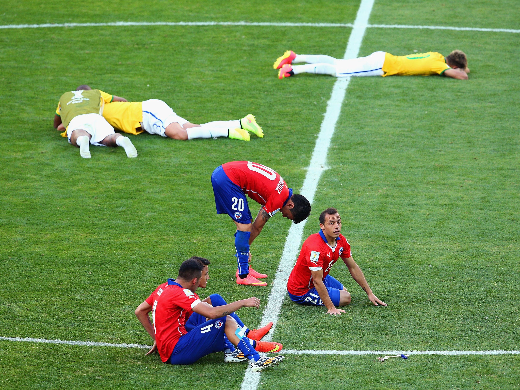 Chile and Brazil players react after seeing Gonzalo Jara miss the crucial penalty