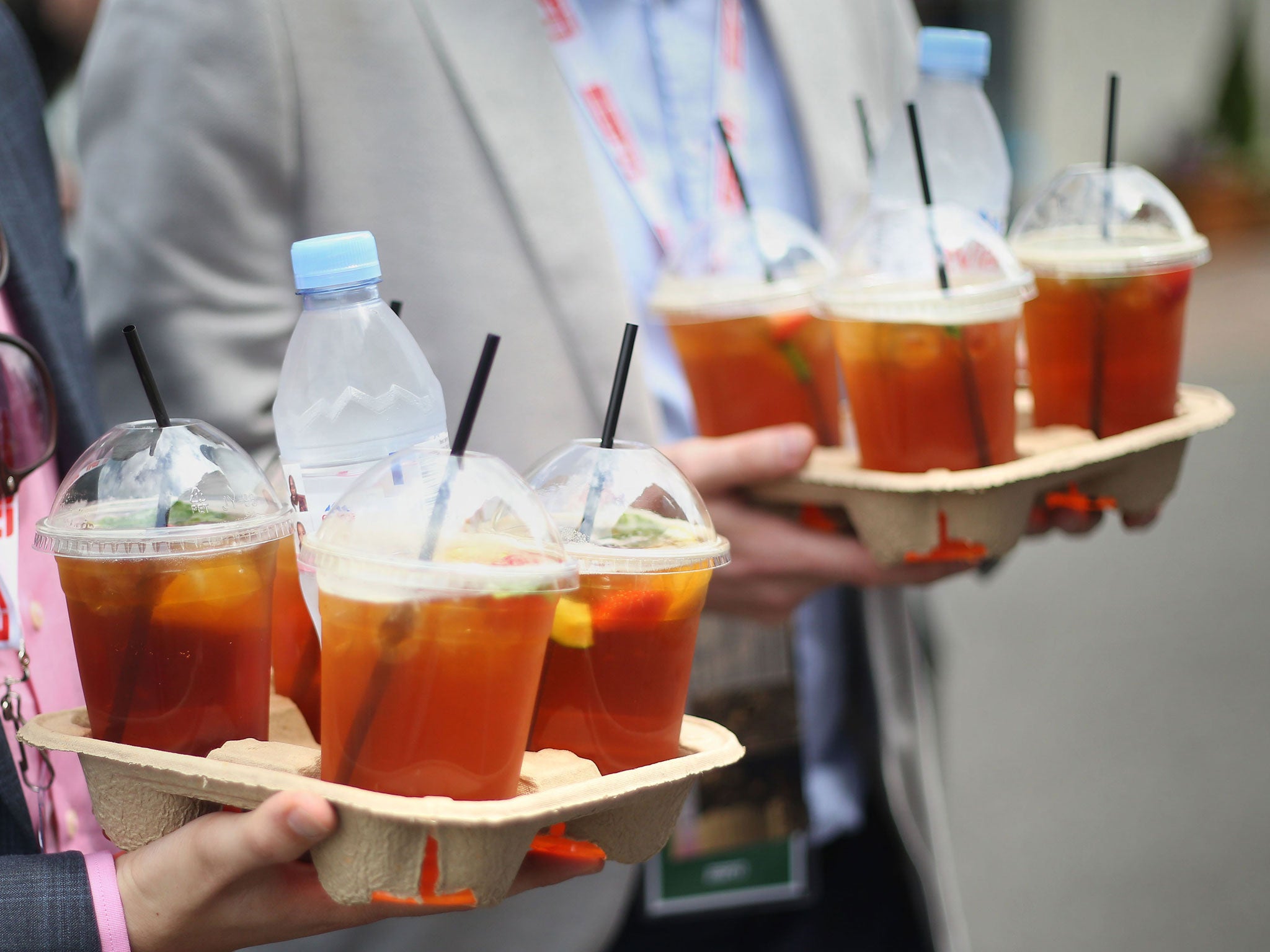 Spectators carrying glasses of Pimm's