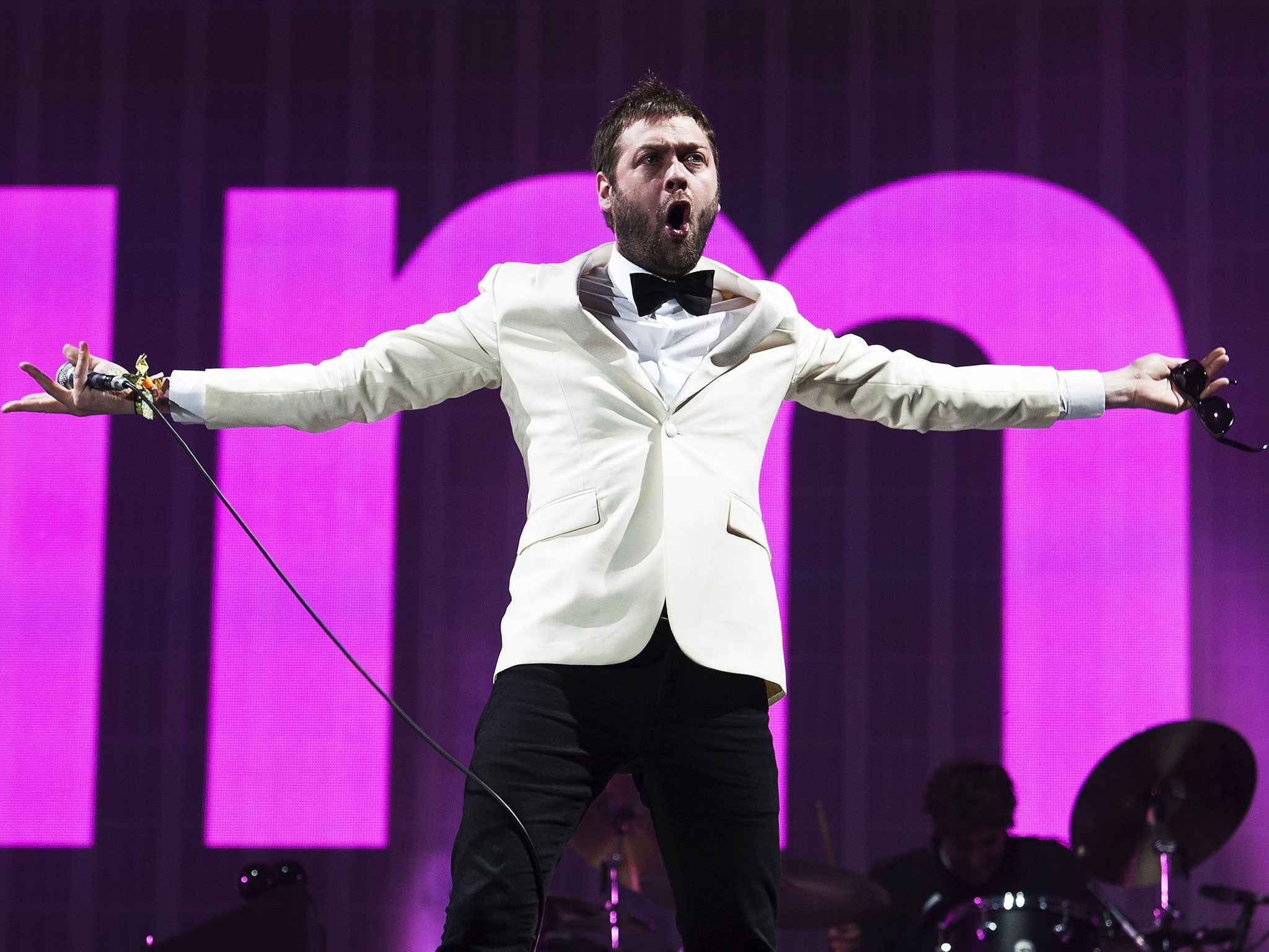 Kasabian frontman Tom Meighan performs on the Pyramid Stage at Glastonbury in 2014
