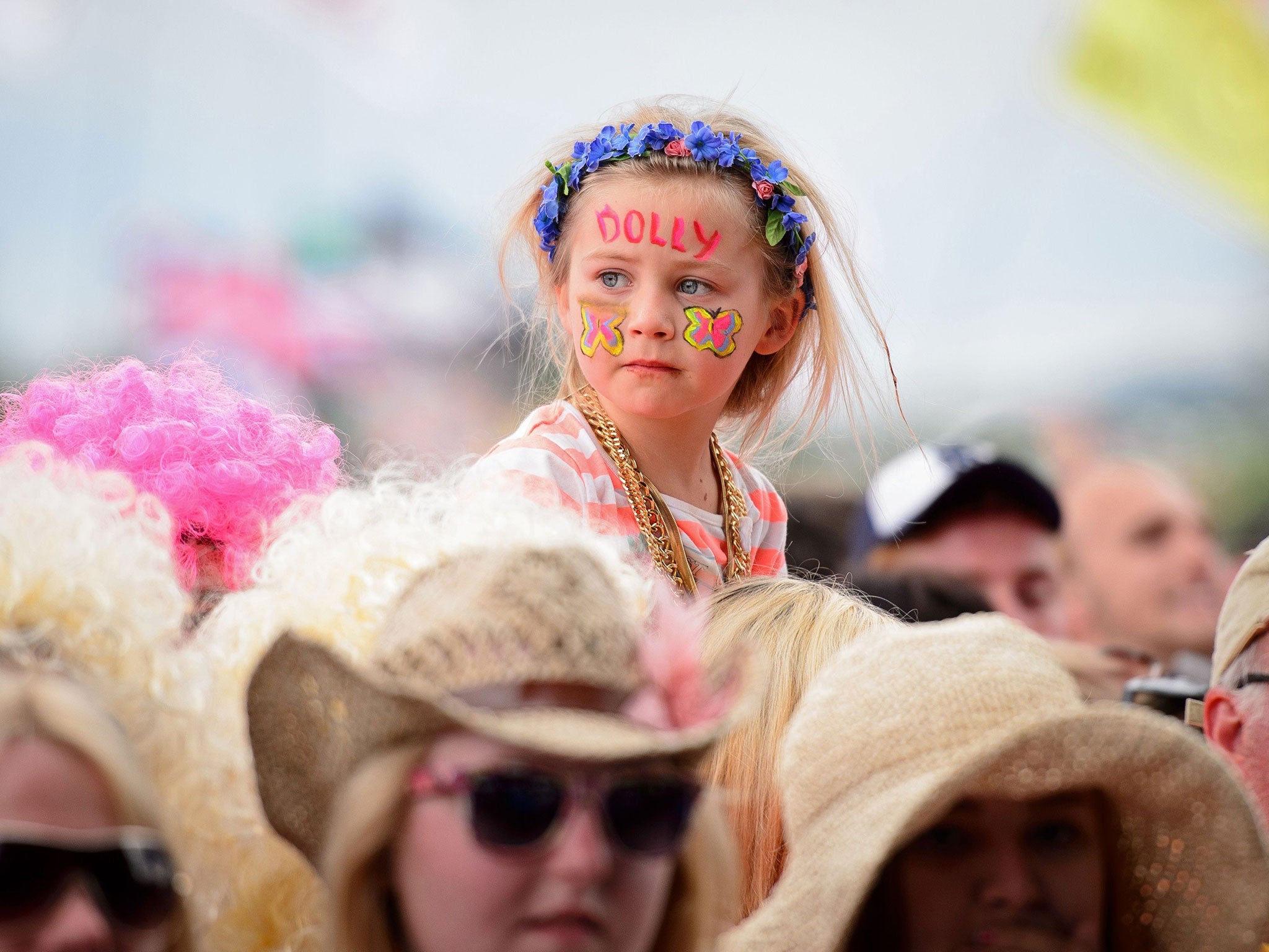 Fans enjoy the music as US singer Dolly Parton performs on the Pyramid Stage, on the final day of the Glastonbury Festival of Music and Performing Arts on Worthy Farm in Somerset