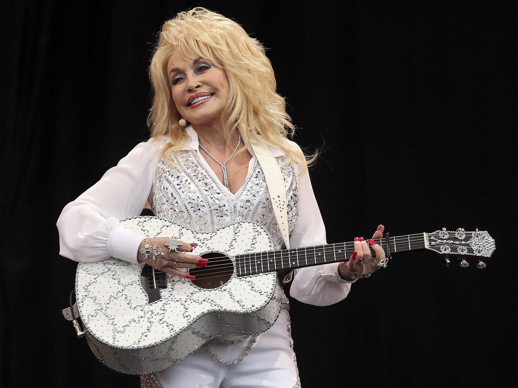 American country music star Dolly Parton performs on the Pyramid Stage at Worthy Farm in Somerset, during the Glastonbury Festival