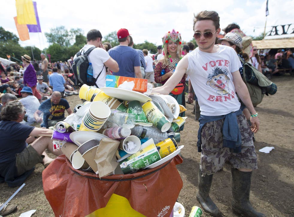 Festival goers use recycling bins at the Glastonbury Festival, at Worthy Farm in Somerset 