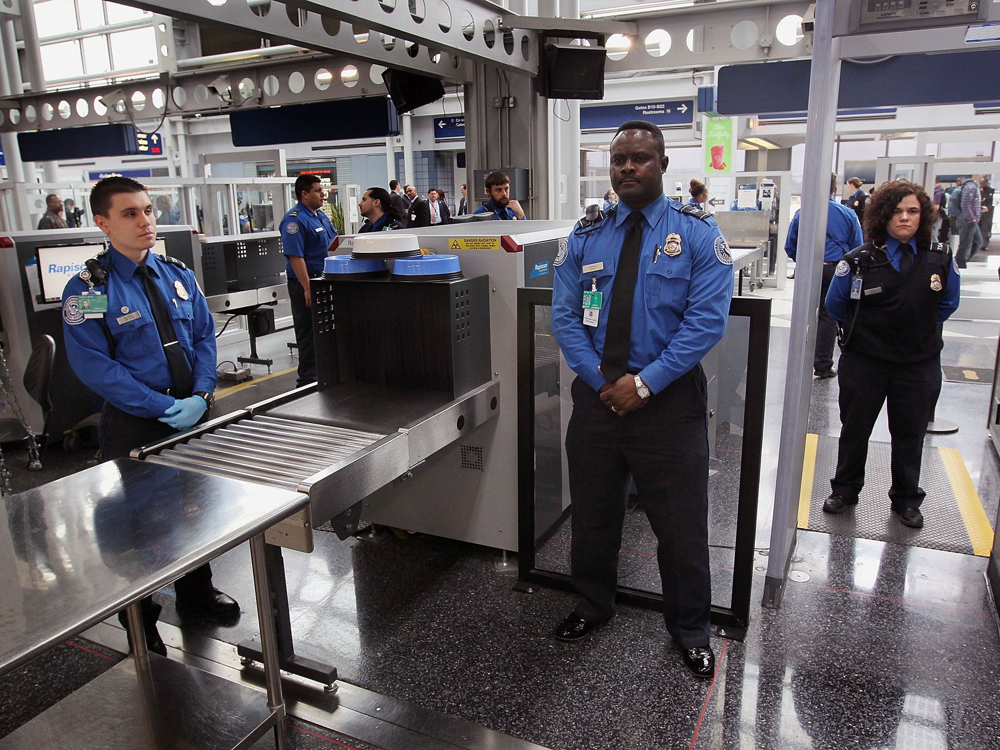 File: Security officers at a checkpoint at O'Hare International Airport in Chicago, Illinois. The US is considering increasing airport security measures in response to a new generation of 'creative' bomb threats from Syrian militant groups