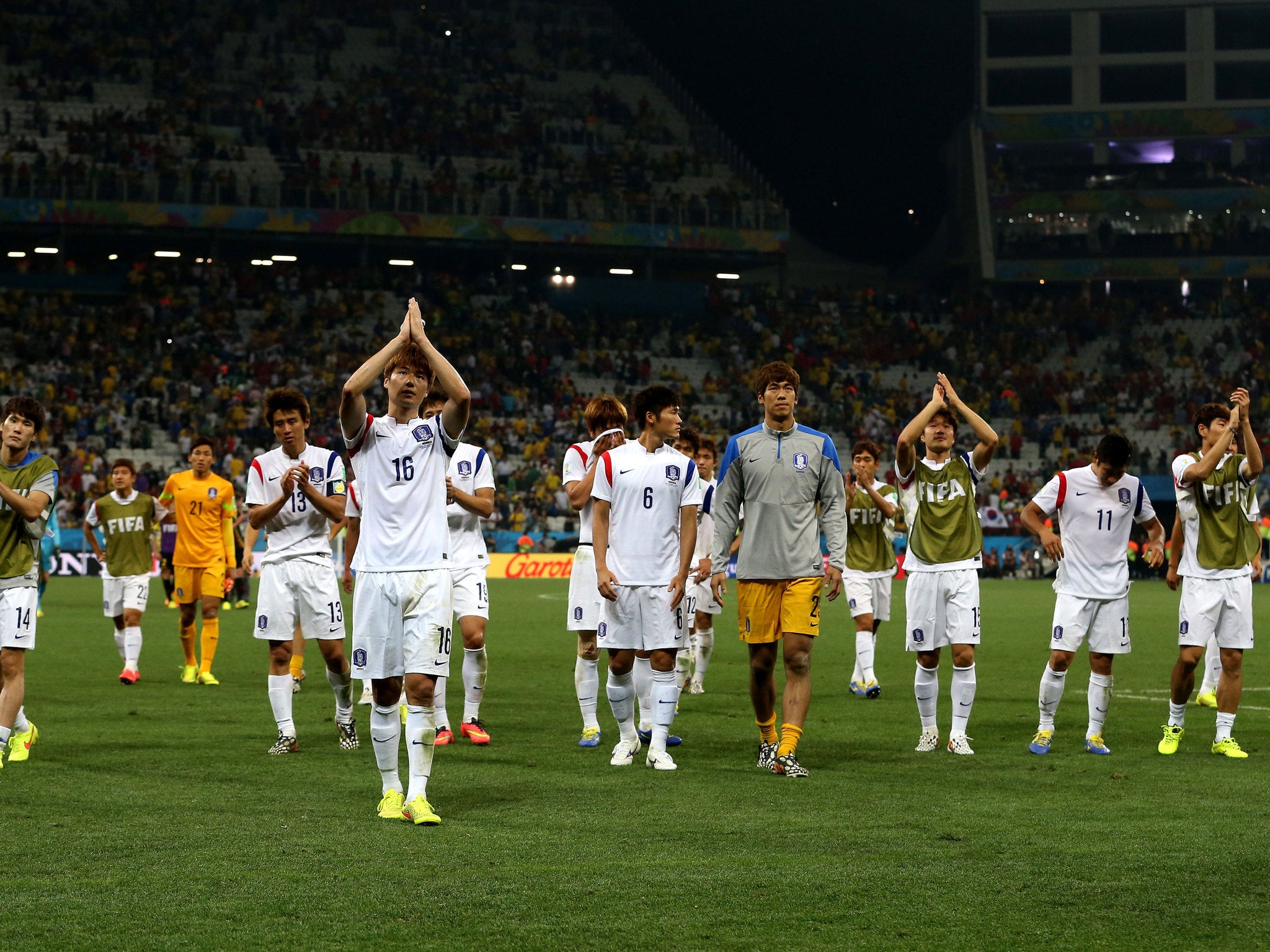 Ki Sung-Yueng of South Korea and teammates acknowledge the fans after a 0-1 defeat to Belgium in the 2014 FIFA World Cup Brazil Group H match between South Korea and Belgium at Arena de Sao Paulo on June 26, 2014 in Sao Paulo, Brazil.