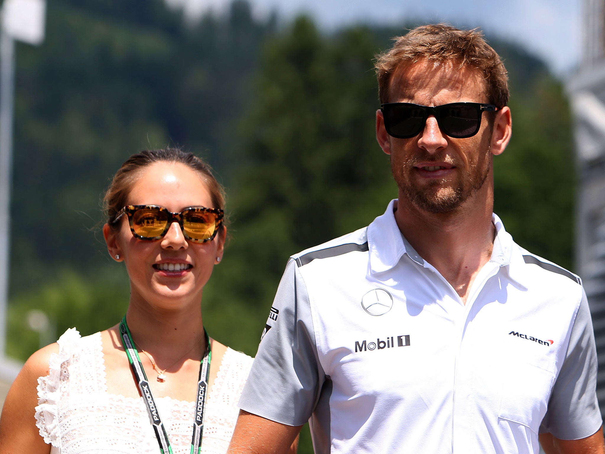 Jenson Button of Great Britain and McLaren arrives in the paddock with his girlfriend Jessica Michibata ahead of the Austrian Formula One Grand Prix