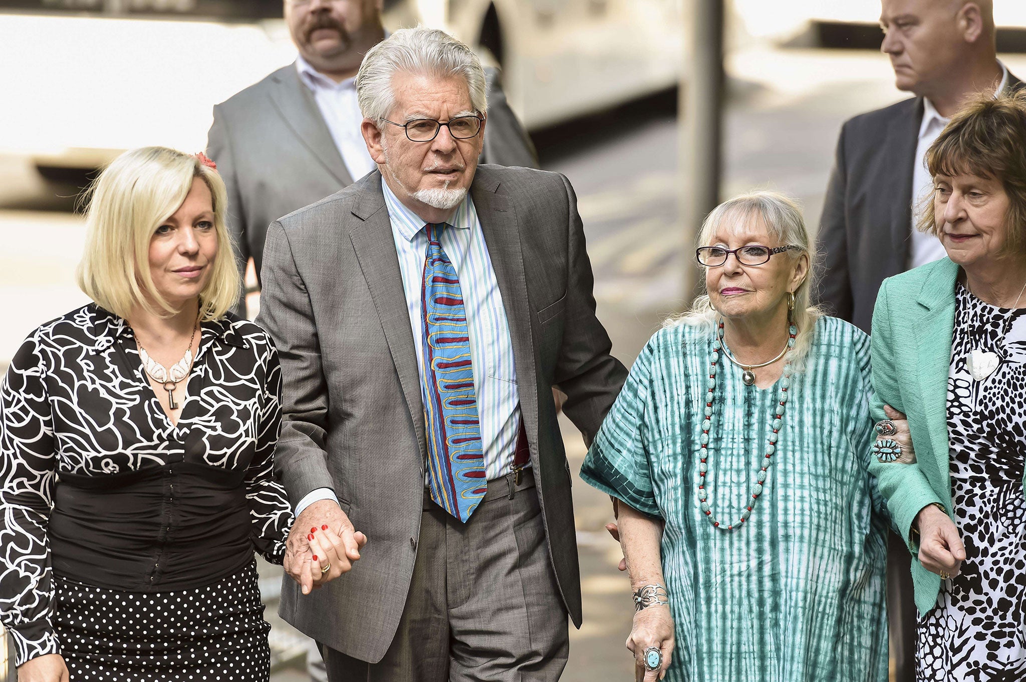 Rolf Harris arrives with his wife Alwen Hughes (R) and daughter Bindi (L) at the Southwark Crown Court in central London today