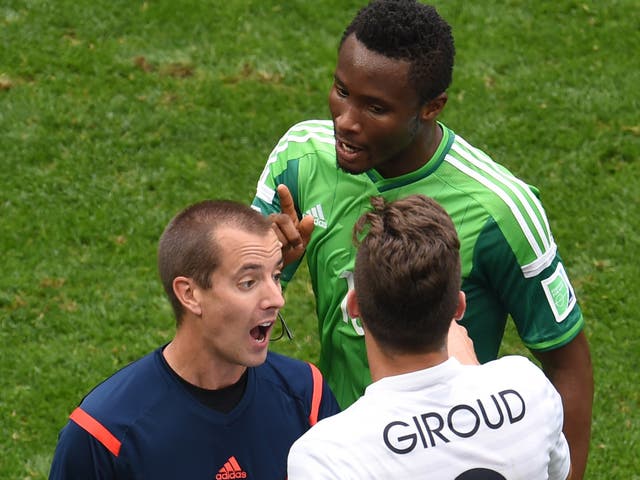 Olivier Giroud and John Obi Mikel remonstrate with the referee