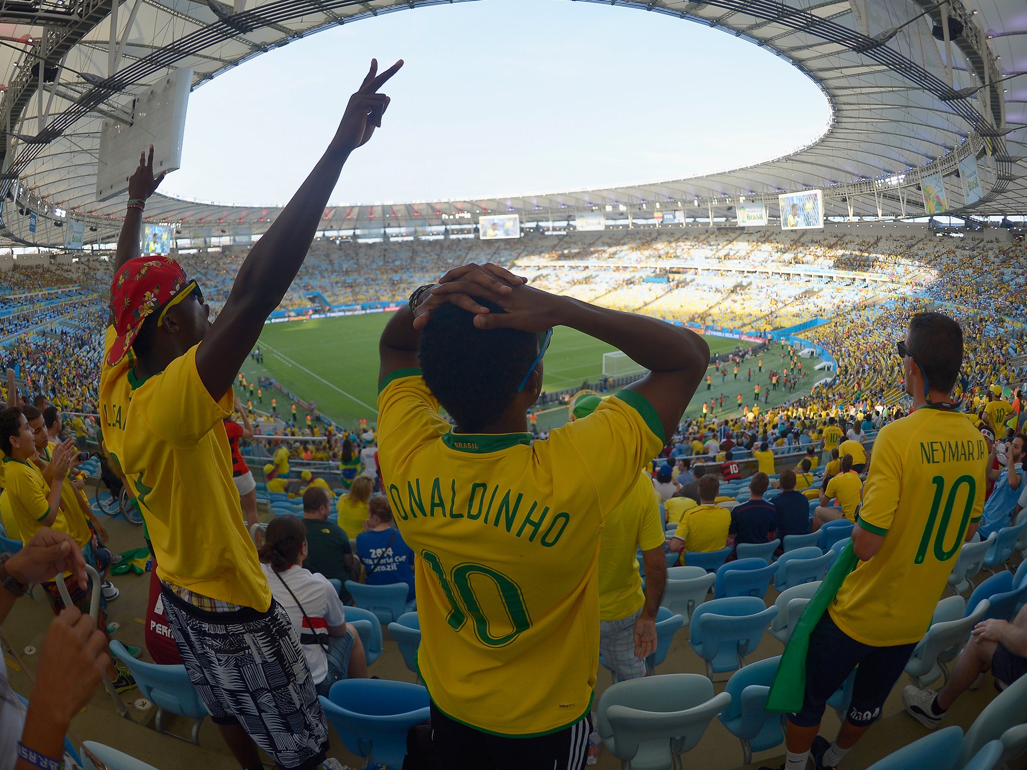 Brazil fans show their emotions as they watch the Brazil and Chile penalty shoot out on a big screen