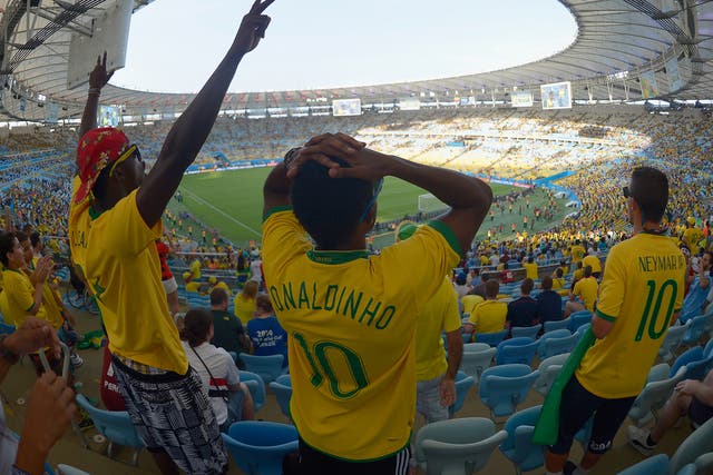 Brazil fans show their emotions as they watch the Brazil and Chile penalty shoot out on a big screen