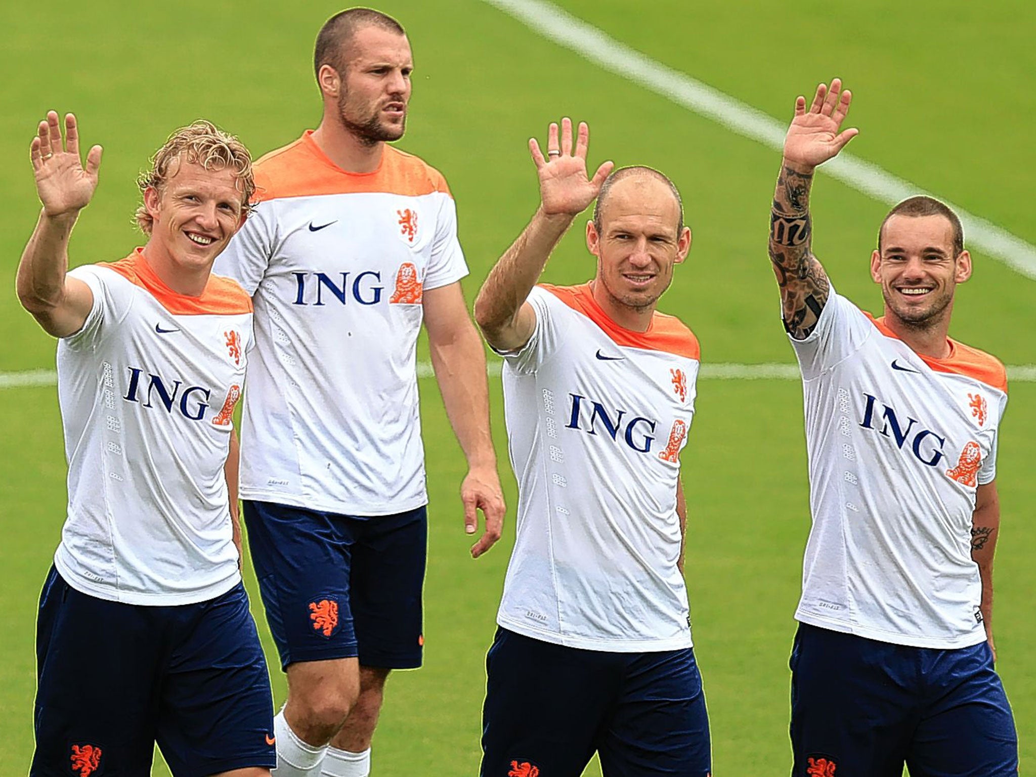 Dirk Kuyt, Ron Vlaar, Arjen Robben and Wesley Sneijder wave to their families during training today