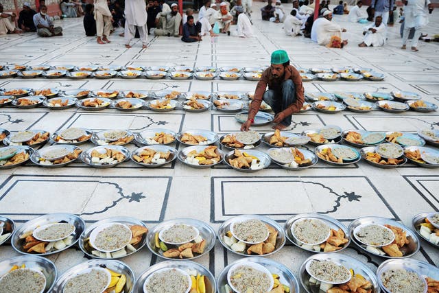 A Pakistani Muslim man arranges Iftar food for Muslim devotees before they break their fast during the holy fasting month of Ramadan in Karachi 