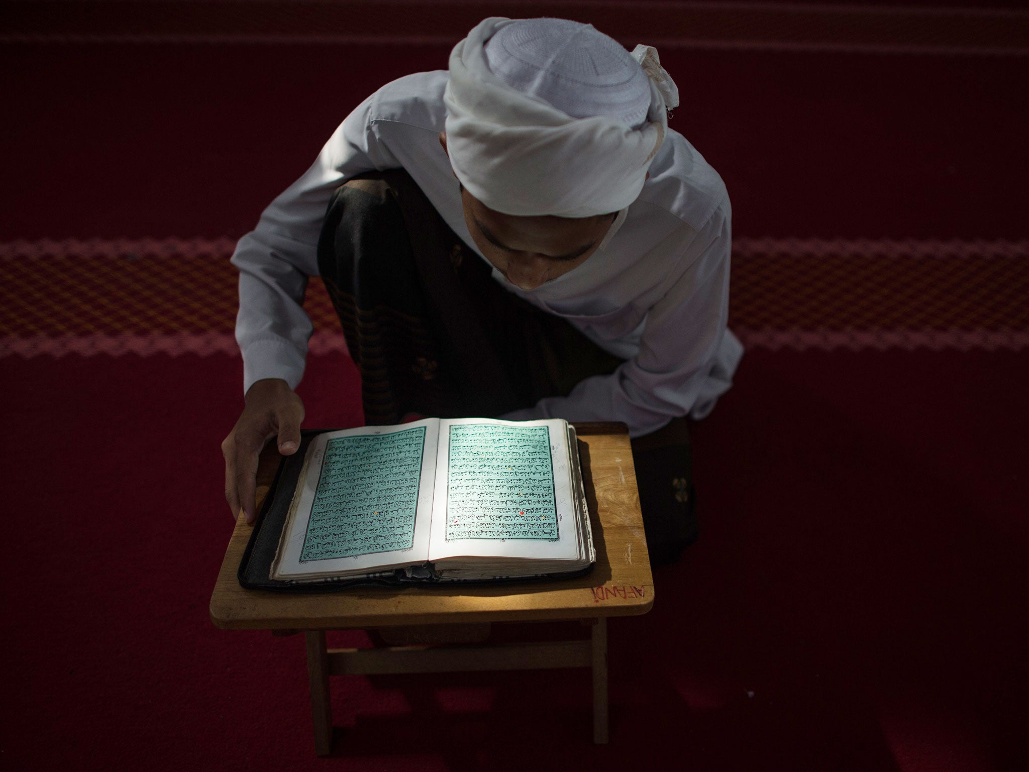 A Malaysian religious student reads the Koran at school during the Muslim holy fasting month of Ramadan in Hulu Langat, near Kuala Lumpur