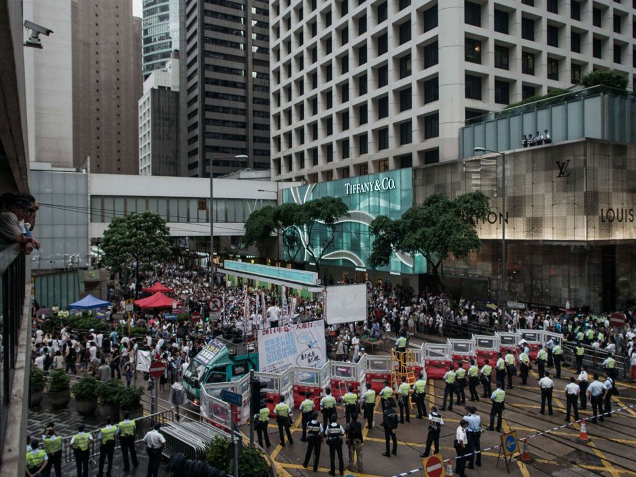 Policemen block a street in the central district during the rally for greater democracy in Hong Kong on July 1