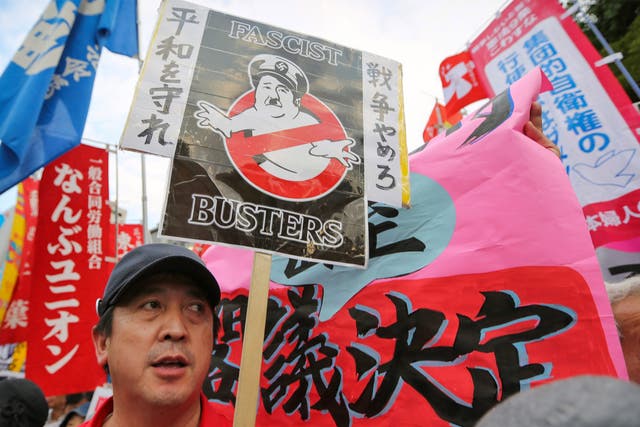 Protesters with anti-war placards hold a mass rally outside the Prime Minister’s office in Tokyo