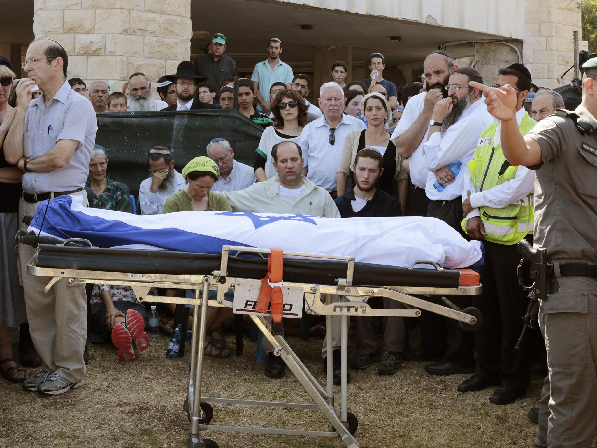 The parents and other family members of Naftali Frankel, one of the three Israeli teens found dead, attend his funeral service in Nof Ayalon, Israel
