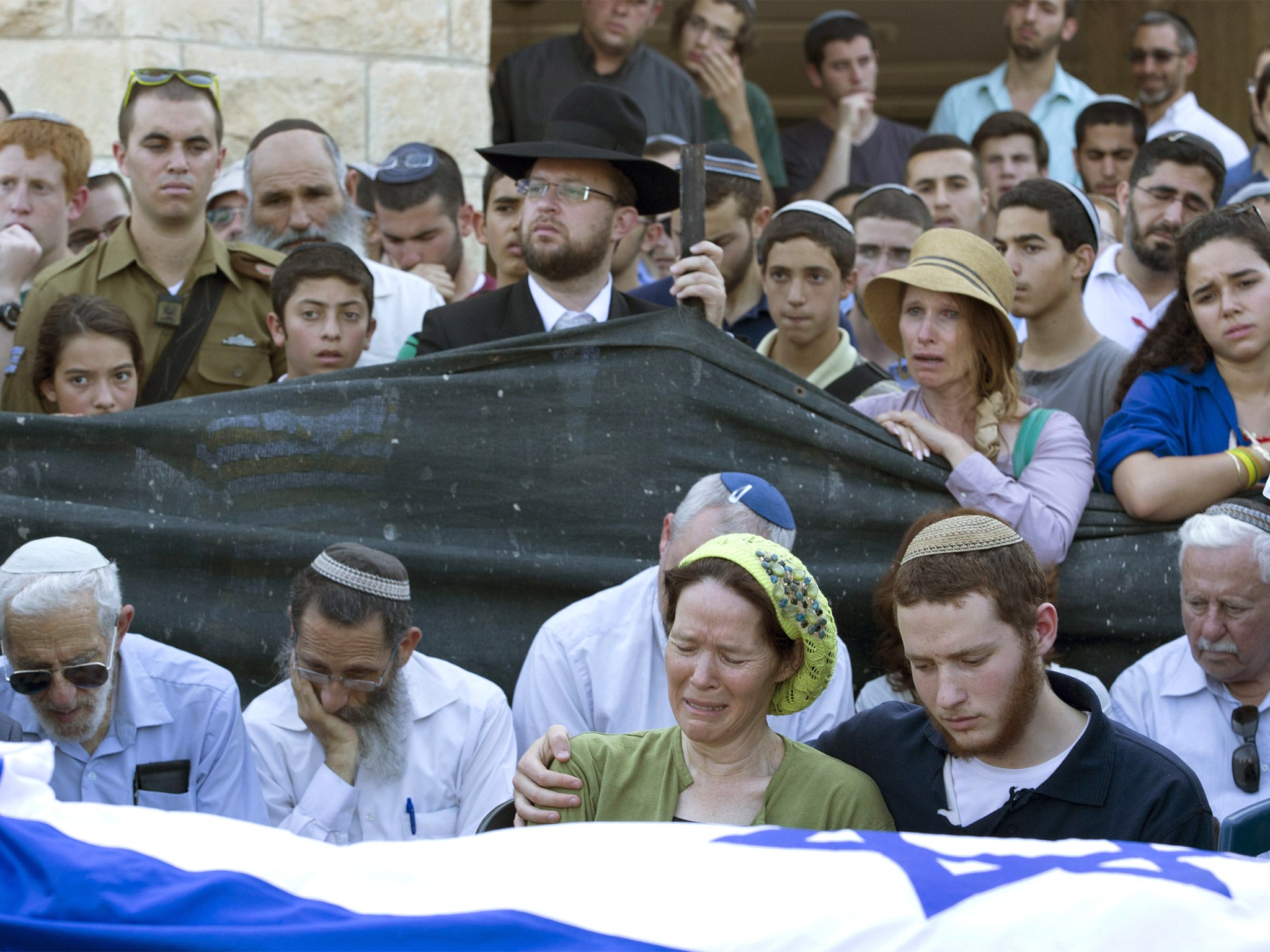 Avi and Rachel Fraenkel attend the funeral of their son, Naftali, a 16-year-old with dual Israeli-American citizenship, in their town of Nof Ayalon