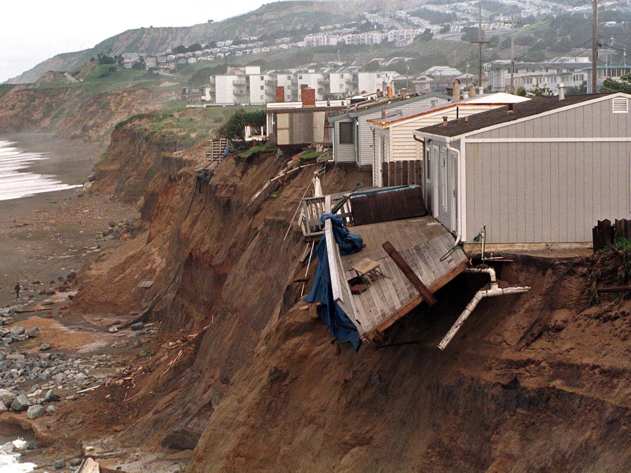 Homes in Pacifica, California, slide into the ocean during the 1997-98 El Nino event which caused extreme weather worldwide