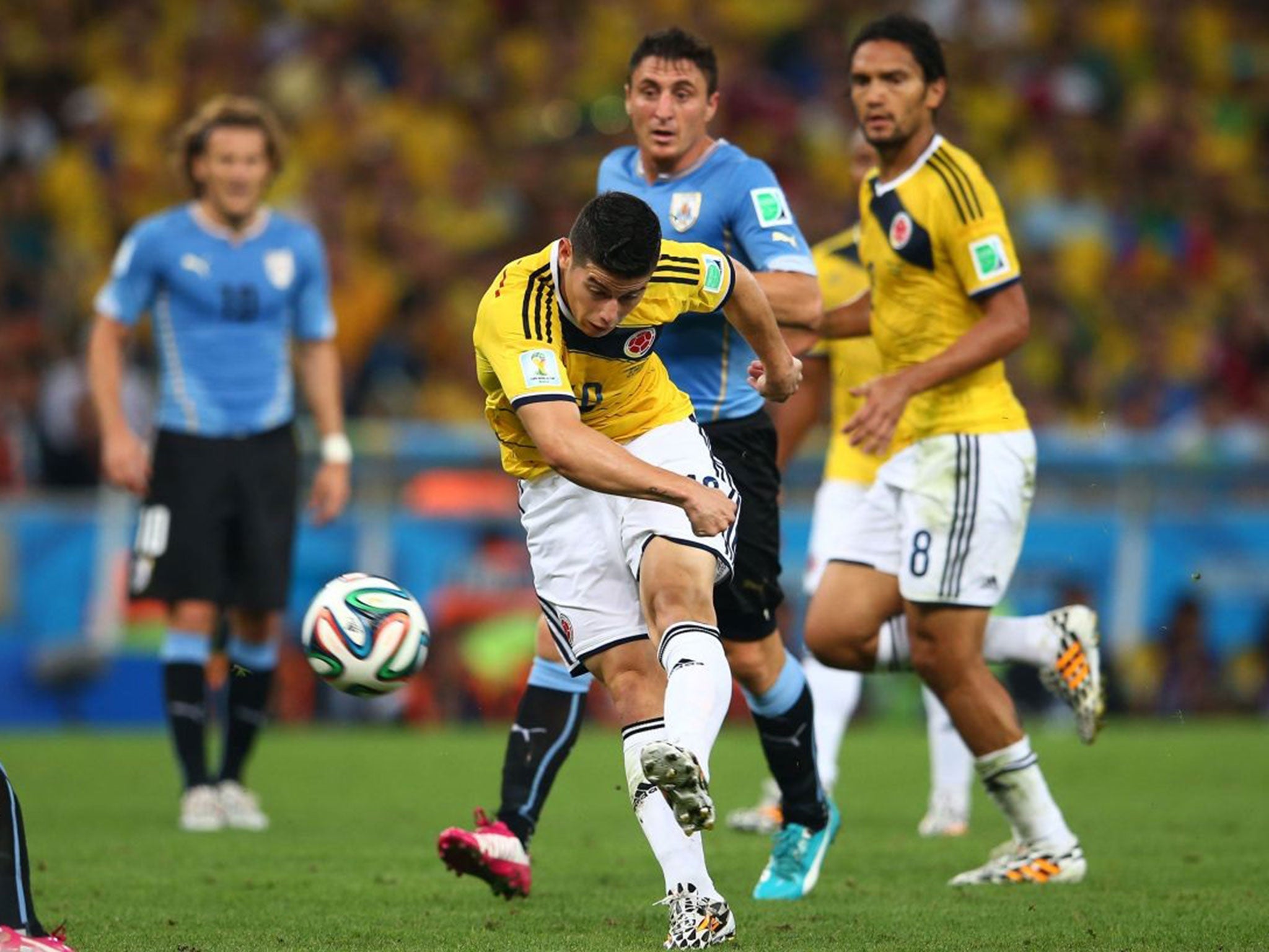 James Rodriguez shoots and scores his team's first goal during the 2014 FIFA World Cup Brazil round of 16 match between Colombia and Uruguay at Maracana on June 28, 2014